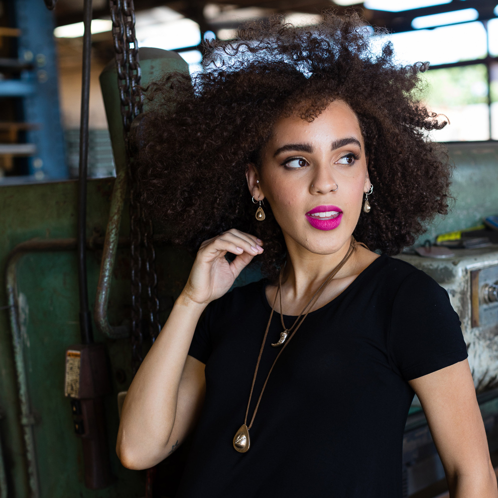 Model wearing the Chile and Avocado Pendants and Avocado Earrings