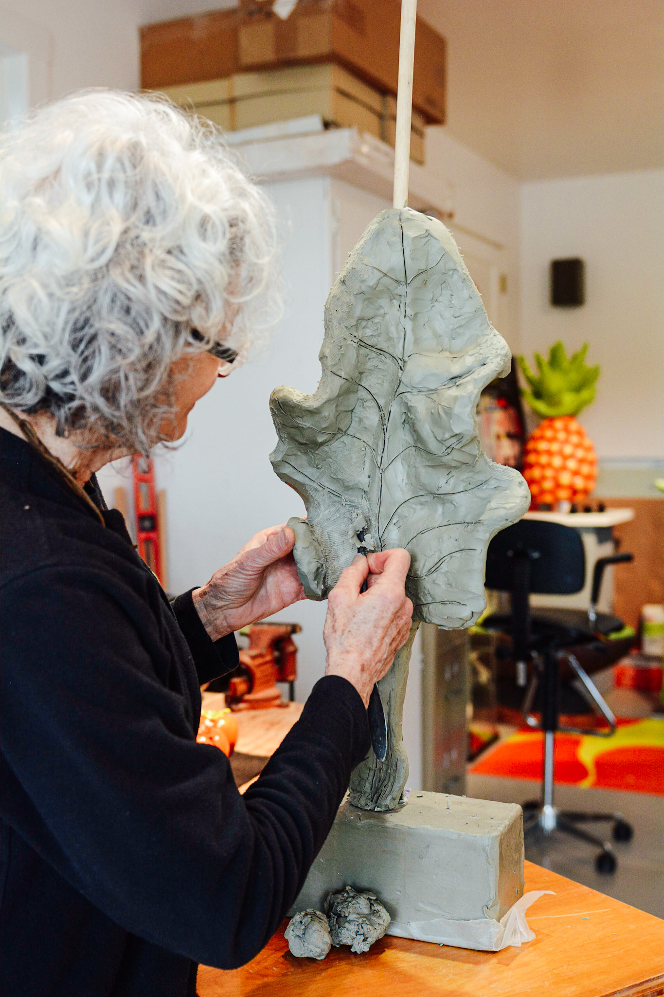 Jan Kirsh in her St. Michaels, Md., studio, working on the details of a kale leaf sculpture